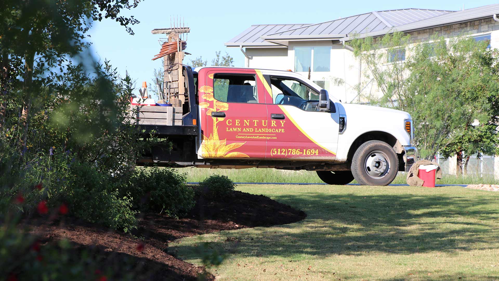 Century Lawn and Landscape work truck at a home in Austin, TX.