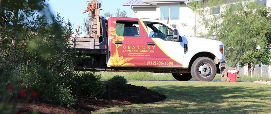 Century work truck displayed beside freshly installed mulch bed in Dripping Springs, TX.