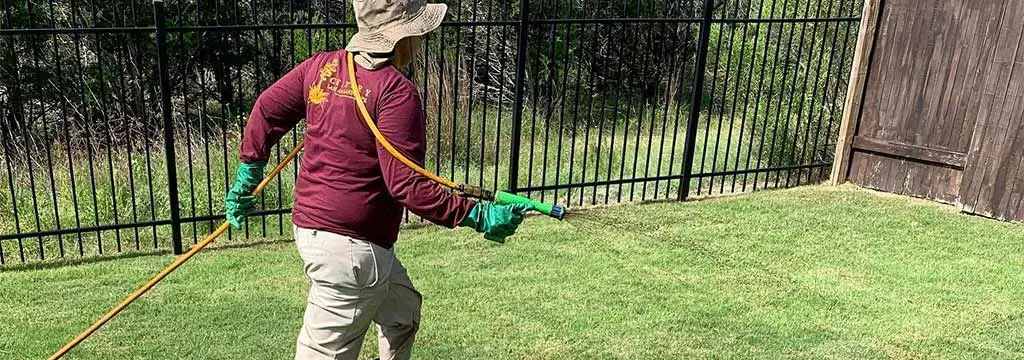 Century professional applying liquid fertilizer to lawn in Austin, TX.